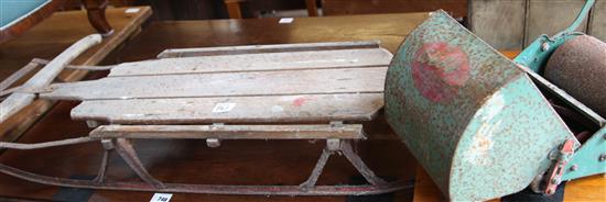Toy lawn mower and a sledge
